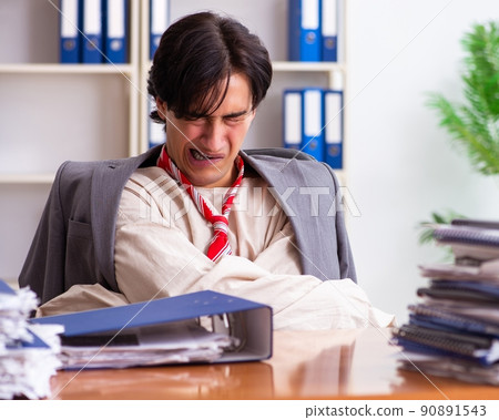 Crazy young man in straitjacket at the office 90891543