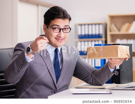 Businessman receiving parcel in the office Businessman receiving parcel in the office 90891654