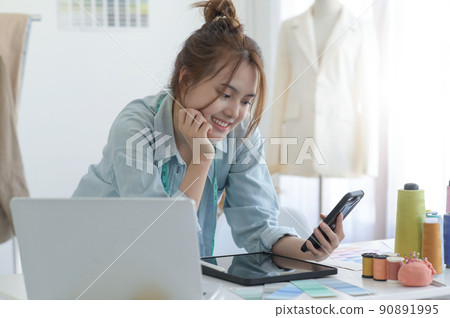 Young woman designer clothing, clothing designer workspace, clothing design accessories. Young woman designer clothing, clothing designer workspace, clothing design accessories. 90891995