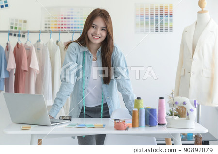 Young woman designer clothing, clothing designer workspace, clothing design accessories. Young woman designer clothing, clothing designer workspace, clothing design accessories. 90892079