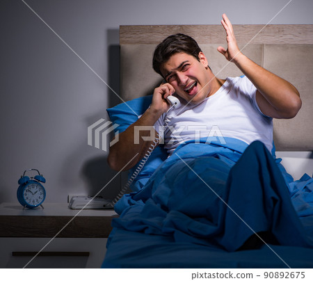 Young man struggling from noise in bed 90892675
