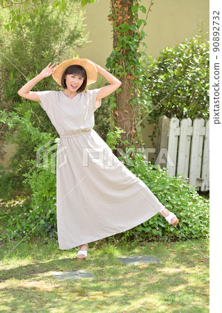 Young woman wearing a straw hat outdoors Young woman wearing a straw hat outdoors 90892732