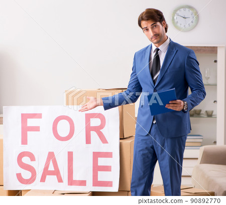 Young handsome realtor selling flat 90892770