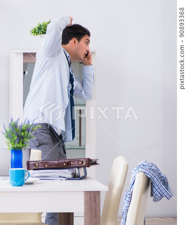 Businessman late for office due to oversleeping after overnight Businessman late for office due to oversleeping after overnight 90893368