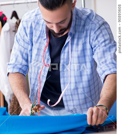 Male tailor working in the workshop on new designs 90893608