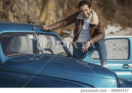 man driving a retro car 90894337