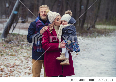 young family walking in the park in winter young family walking in the park in winter 90894404