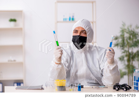 Young male chemist working at the lab during pandemic 90894789
