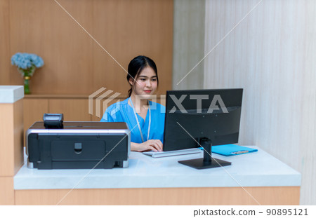 Woman Healthcare worker using laptop in hospital. 90895121