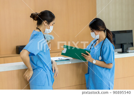 Female doctor stands at hospital. Healthcare worker.  90895540