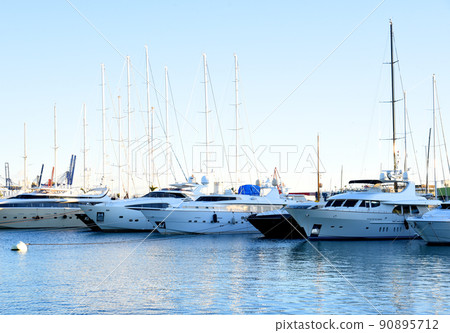 Yachts and motor boats in La Marina de Valencia, Spain. 90895712