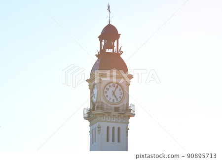 Clock tower building. Large clock tower with hour hands that shows the time of day and night. Clock tower building. Large clock tower with hour hands that shows the time of day and night. 90895713