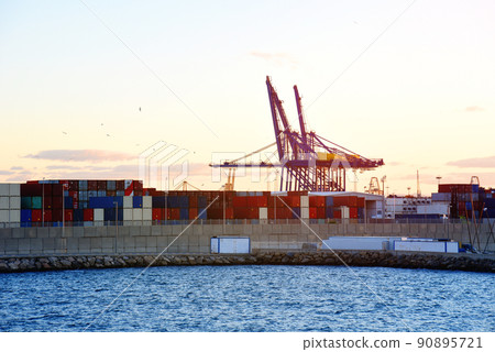 Container crane in seaport on sunset in La Marina de Valencia. Container crane in seaport on sunset in La Marina de Valencia. 90895721