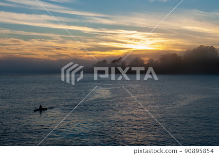 Solitary Canoer at sunset 90895854