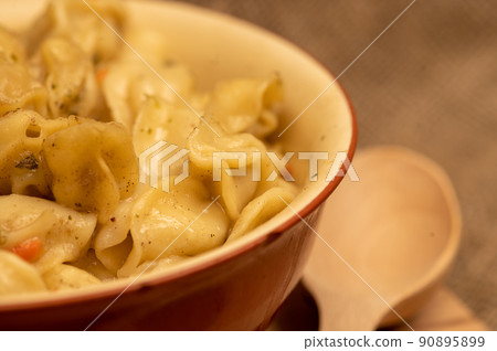 Boiled with spices dumplings with meat in a ceramic bowl. Close-up, selective focus Boiled with spices dumplings with meat in a ceramic bowl. Close-up, selective focus 90895899