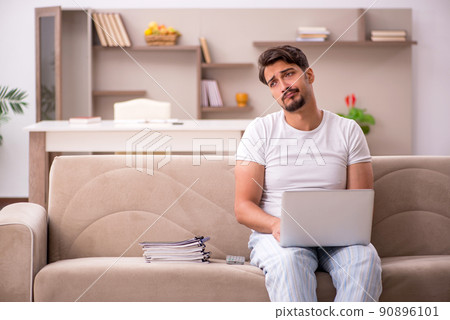 Young male employee working from home during pandemic 90896101