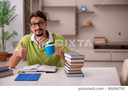 Young male student studying at home Young male student studying at home 90896792