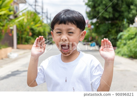 Child face messy and dirty by chocolate ice cream. Child face messy and dirty by chocolate ice cream. 90896821