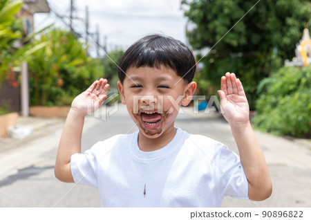 Child face messy and dirty by chocolate ice cream.  90896822
