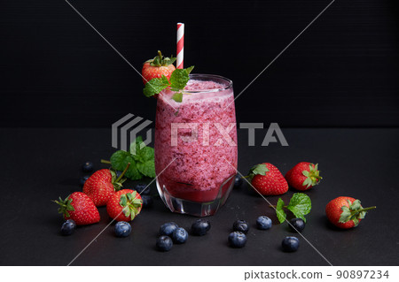 Delicious strawberry, mulberry and blueberry smoothie garnished with fresh berries and mint in glass. soft focus. beautiful appetizer pink raspberries, well being and weight loss concept. Delicious strawberry, mulberry and blueberry smoothie garnished with fresh berries and mint in glass. soft focus. beautiful appetizer pink raspberries, well being and weight loss concept. 90897234