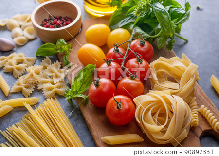 Mixed dried pasta selection on wooden background. composition of healthy food ingredients isolated on black stone background, top view, Flat lay. 90897331