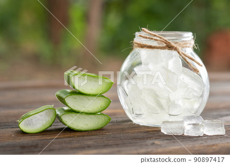 Aloe Vera on product display wood counter background. aloe vera is tropical green plants. Sliced Aloe Vera natural organic renewal cosmetics, alternative medicine. Organic Skin care concept. 90897417