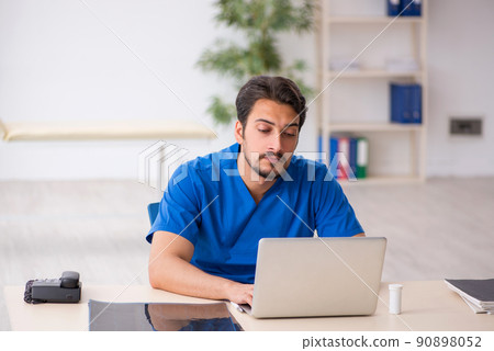 Young male doctor in telemedicine concept Young male doctor in telemedicine concept 90898052