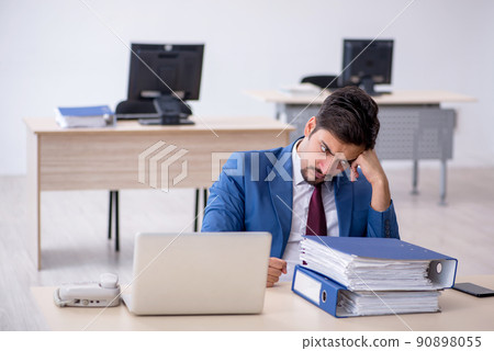 Young male employee working in the office Young male employee working in the office 90898055