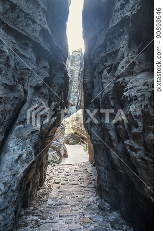 Narrow path between rocks in sandstone mountains Narrow path between rocks in sandstone mountains 90898646