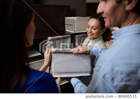 Testing a sample of orthopedic mattress in furniture store. Sales manager and customers shopping for bedding items. Healthy sleep Testing a sample of orthopedic mattress in furniture store. Sales manager and customers shopping for bedding items. Healthy sleep 90900533