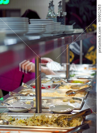 Path at night in the park of the resort. Recreation area on the territory of the resort with lampposts. 90901263