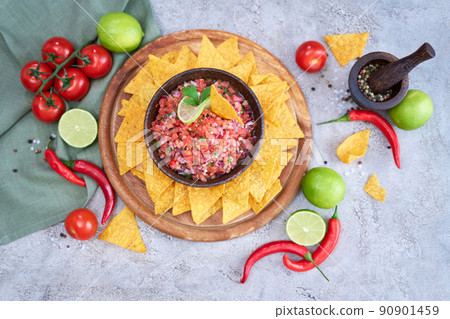freshly made salsa dip sauce with nacho chips on wooden board freshly made salsa dip sauce with nacho chips on wooden board 90901459