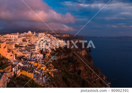 The skyline of Fira on the cliffs of Santorini, Greece and the sky dyed by the sunset 90902391