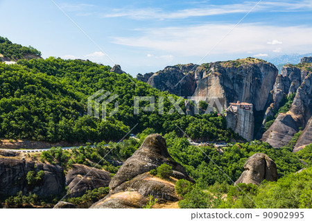 The Rusanu Monastery on the rocky cliffs of Meteora, Greece, and the surrounding strange rock formations The Rusanu Monastery on the rocky cliffs of Meteora, Greece, and the surrounding strange rock formations 90902995