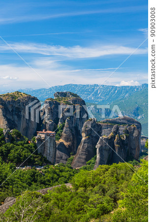 The Rusanu Monastery on the rocky cliffs of Meteora, Greece, and the surrounding strange rock formations The Rusanu Monastery on the rocky cliffs of Meteora, Greece, and the surrounding strange rock formations 90903008