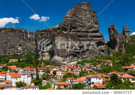 The streets of Kastraki, Greece, the rock formations of Meteora behind, and the Monastery of St. Nicholas Anapahusas 90903757
