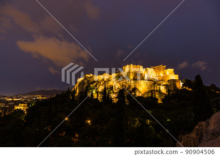 Acropolis and Parthenon illuminated at night seen from the Areopagus hill in Athens, Greece 90904506