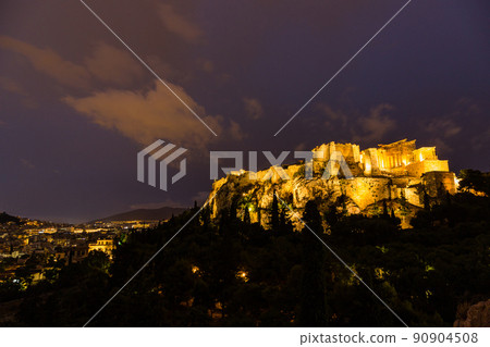 Acropolis and Parthenon illuminated at night seen from the Areopagus hill in Athens, Greece 90904508