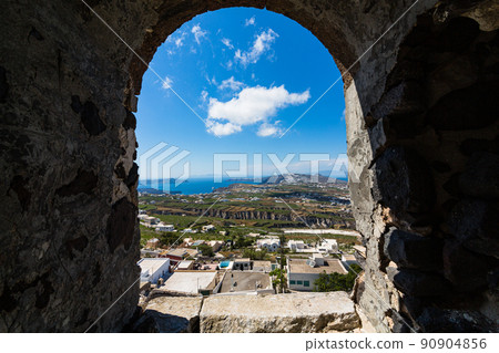 View of the entire island from the hill of the castle ruins of the village of Pilgos on Santorini, Greece 90904856