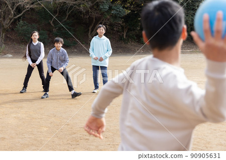 Elementary school students playing dodgeball Elementary school students playing dodgeball 90905631