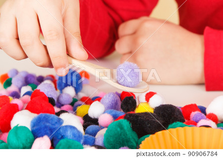 Little baby boy playing with small pompoms, wooden spoon and cups. Development of kids motor skills Little baby boy playing with small pompoms, wooden spoon and cups. Development of kids motor skills 90906784