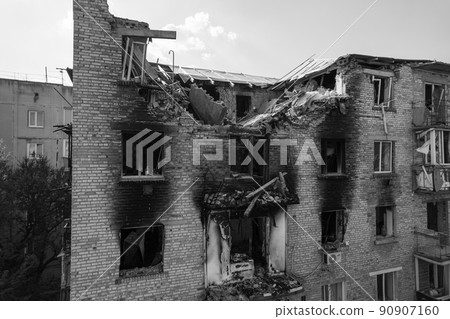 War in Ukraine - destroyed building in Makariv, black and white photo 90907160
