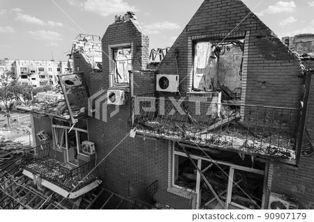 War in Ukraine - destroyed building in Makariv, black and white photo 90907179