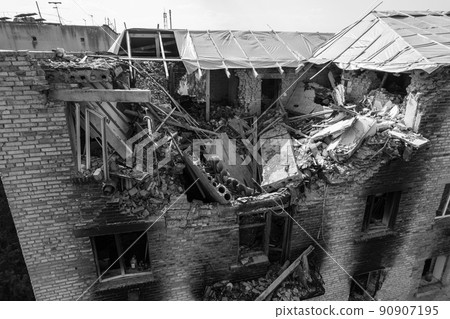 War in Ukraine - destroyed building in Makariv, black and white photo 90907195