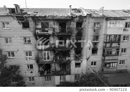 War in Ukraine - destroyed building in Makariv, black and white photo 90907228