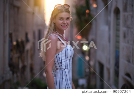 Fashionably dressed woman on the streets of a small Italian town 90907264