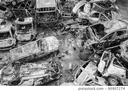War-destroyed cars in Irpin, Bucha district, Ukraine, black and white 90907274