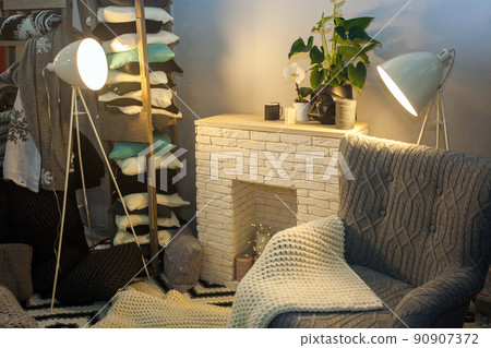 comfortable home inside in gray color with white fireplace and lamp. 90907372