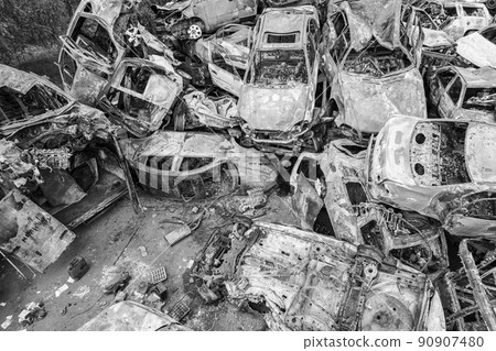War-destroyed cars in Irpin, Bucha district, Ukraine, black and white War-destroyed cars in Irpin, Bucha district, Ukraine, black and white 90907480