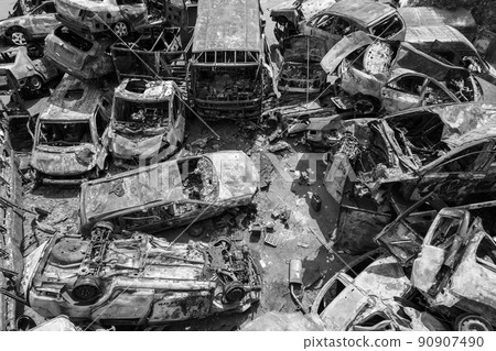 War-destroyed cars in Irpin, Bucha district, Ukraine, black and white 90907490